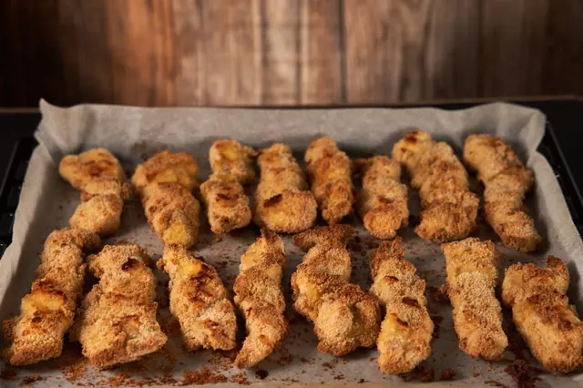 Baked chicken cutlets on tray