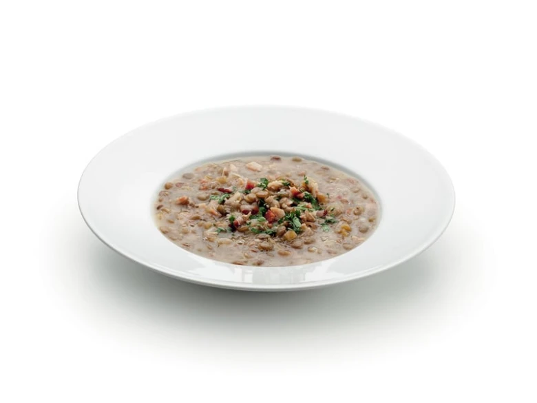 Hot bowl of Czech lentil soup ready to serve.