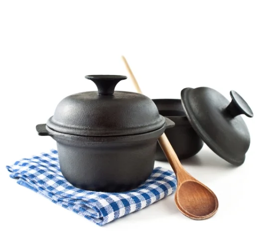 Black clay pot with lid and wooden spoon