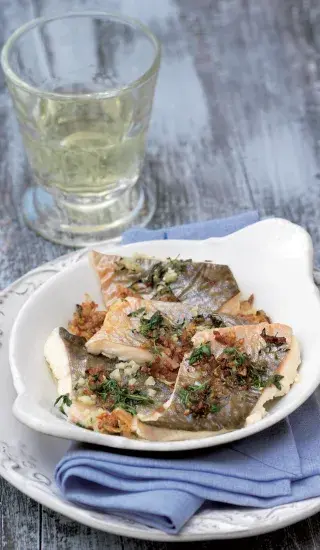 Cooked fish fillets with herbs and sauce
