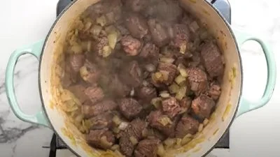 Maďarský guláš se vaří v hrnci s masem a zeleninou.