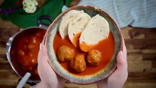 Baked meatballs in sauce with bread