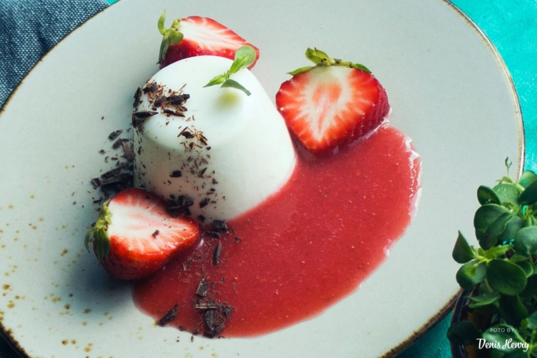 Strawberry panna cotta s podáváním na talíři s čokoládou.