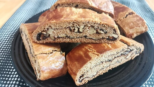 Na talíři jsou nakrájené klasické české žemlovky s ořechy.