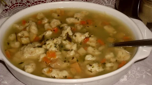 Yeast dumpling soup with herbs and carrots
